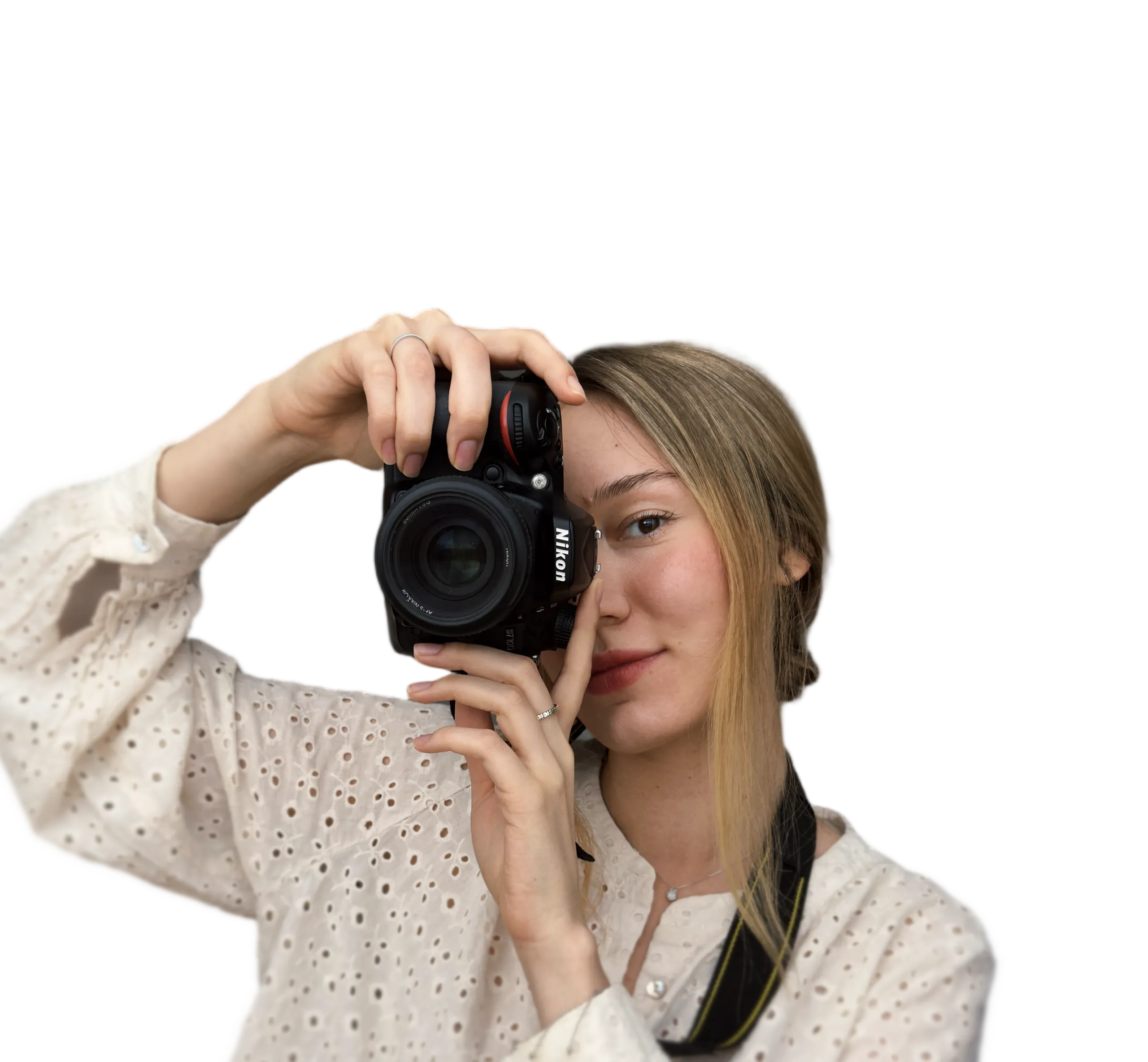 Portrait of a young woman holding a Nikon DSLR camera, showcasing a professional photographer's style in Vienna.